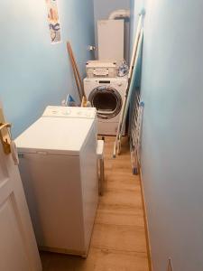 a laundry room with a washing machine and a washer at Au Cœur d Etaples in Étaples +3 photos