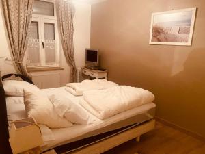 a bedroom with a bed and a television on a table at Au Cœur d Etaples in Étaples