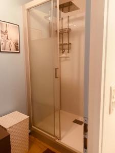 a shower with a glass door in a bathroom at Au Cœur d Etaples in Étaples