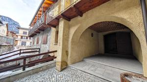 an entrance to a building with an archway at Hostdomus - Flower Loft in Cesana Torinese