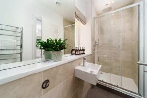 a bathroom with a sink and a shower at Tree Top - Perfect Apartment For Relaxing Getaway, Balcony, Parking in Lynmouth