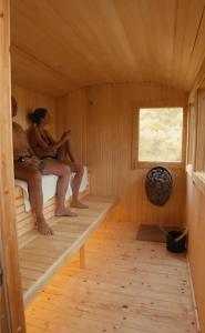a group of people sitting in a sauna at Tree Top - Perfect Apartment For Relaxing Getaway, Balcony, Parking in Lynmouth +6 photos