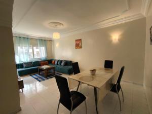 a living room with a table and a couch at Chez Atlas in Kenitra