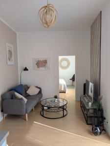 a living room with a couch and a table at Appartement Napoleon in Meißen
