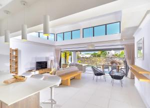 a living room with a couch and a table at Corail Bleu Private Villas with LOV in Bain Boeuf