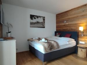 a bedroom with a bed with a cat on it at Appartement Paulina Kaprun in Kaprun