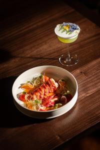 a bowl of food on a table next to a drink at Vico Milano in Milan