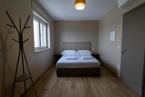 a bedroom with a bed and a large window at D'Stay in Bari