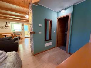 a living room with blue walls and a couch at Dolomiti Nest in Tesero