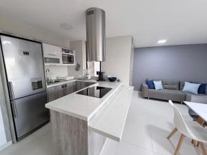 a kitchen and living room with a refrigerator freezer at Playa el Ángel Apartment in Pampatar