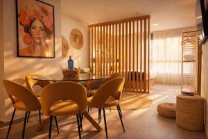 a dining room with a glass table and chairs at DozZze Julieta in Alicante +81 photos