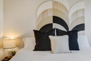 a bedroom with a bed with a black and white headboard at Urban Float in Colorado Springs