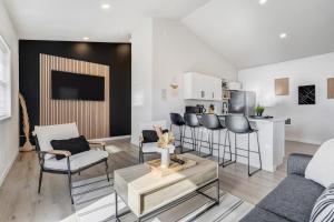 a living room with chairs and a table and a kitchen at Urban Float in Colorado Springs