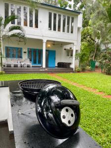 a black bowl on a table in front of a house at La Maison Bougainvillea in Mahabalipuram