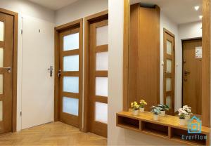 a hallway with a wooden door and a mirror at Deer Room - 5 Minutes to Sopot Molo & Seaside in Sopot