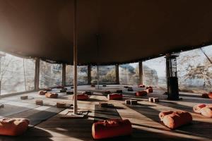 a room with large windows and red objects on the floor at Watersmeet Point in Lynmouth +4 photos