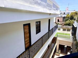 a balcony view of a white building with a door at La Brisa Loca Prime in Santa Marta