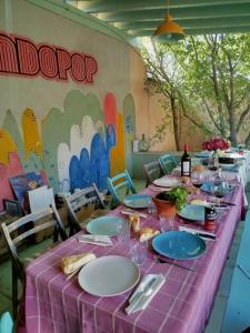 a table with a purple table cloth and plates and wine bottles at Loft La buena vida in Peñaranda de Duero