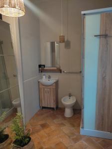 a bathroom with a sink and a toilet and a mirror at Appartamento in Villa in Mondaino
