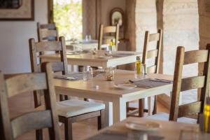 a dining room with tables and chairs with glasses on them at Finca Binibona Parc Natural in Binibona