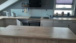 a kitchen with a wooden counter top in a kitchen at Ferienwohnung Seeblick in Wustrow