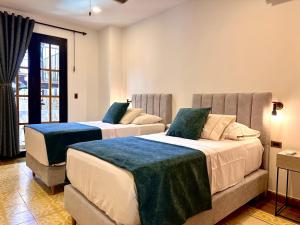 a bedroom with two beds with blue sheets at La Brisa Loca Prime in Santa Marta +18 photos