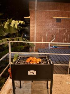 a grill with some food on top of it at hello 6 cliff stay varkalacliff - cozy rooms , couple friendly ,family ,group rooms in Varkala