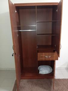 a wooden book shelf with a pillow inside of it at Keur Vieux DIATTA in Ziguinchor