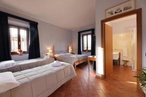 a hotel room with two beds and a mirror at Hotel Locanda dell'Oca Bianca in Como