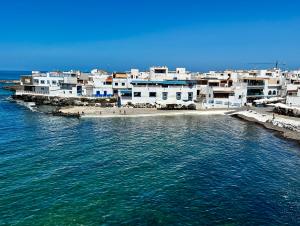 a group of white buildings next to the water at Atlantic Green 3 Apartment, Terrace, Solarium and Spa in El Cotillo