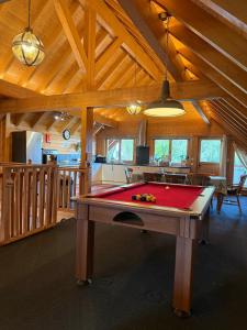 a room with a pool table in a house at Alpine Lodge in Pentney