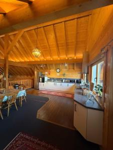 a large room with a kitchen and a dining room at Alpine Lodge in Pentney