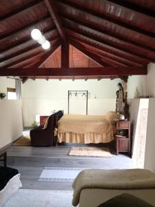 a bedroom with a bed in a room with wooden ceilings at O cantinho da Laura in Lamego
