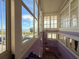 a hallway with windows and a view of the ocean at Beach House Victoria - Beachside - Playa Rincón in Rincón de la Victoria