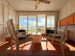 a living room with a table and chairs and a window at Beach House Victoria - Beachside - Playa Rincón in Rincón de la Victoria