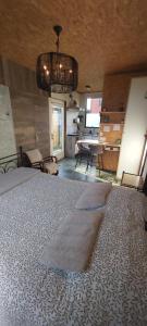 a bedroom with a large bed and a kitchen at Le tiny de Laly - climatisation -wifi - jardin - airport navette in Pont-de-Loup