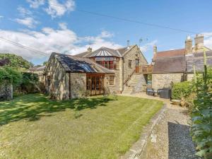 an exterior view of a stone house with a yard at 2 Bed in Hexham oc-88443 in Acomb