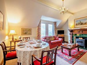 a living room with a table and a fireplace at 3 Bed in Keswick oc-sz135 in Threlkeld