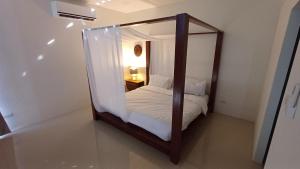 a bedroom with a mirror with a bed in it at Villa Kitima homestay in Ban Chat
