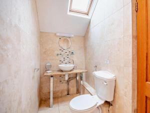 a bathroom with a toilet and a sink at 3 Bed in Keswick oc-sz135 in Threlkeld +18 photos