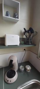 a kitchen counter with a toaster and a sink at Le tiny de Laly - climatisation -wifi - jardin - airport navette in Pont-de-Loup