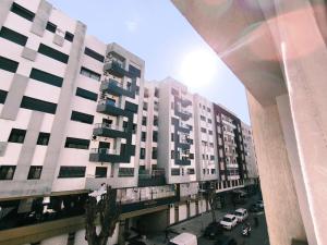 a view of a tall building with a parking lot at Chez Atlas in Kenitra