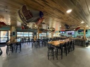 a restaurant with wooden ceilings and tables and chairs at Cass Lake Lodge in Cass Lake