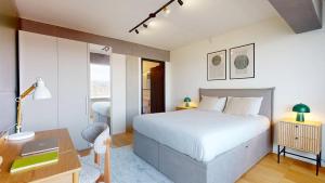 a bedroom with a bed and a desk with a computer at Alto-Tower Residence - Self Check In in Zurich