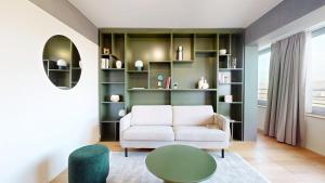 a living room with a white couch and a table at Alto-Tower Residence - Self Check In in Zurich