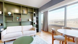 a living room with a white couch and a table at Alto-Tower Residence - Self Check In in Zurich