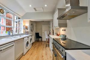 a kitchen with a sink and a dishwasher at Finest Retreats - Aarons in Painswick +14 photos