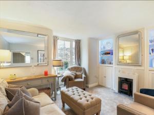 a living room with a couch and a fireplace at Finest Retreats - Aarons in Painswick