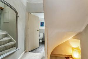 a bathroom with a staircase and a toilet at Finest Retreats - Aarons in Painswick