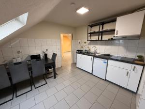 a kitchen with a table and a dining room at Duren Bahnhof in Düren - Eifel